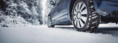 The car stopped on the snowy roadsideの写真素材