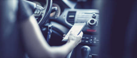 Driver driving a car on asphalt road in summer day at park.の写真素材