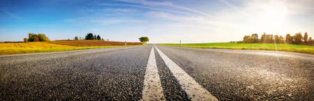 Wide asphalt road panorama in countryside on summer day.の写真素材