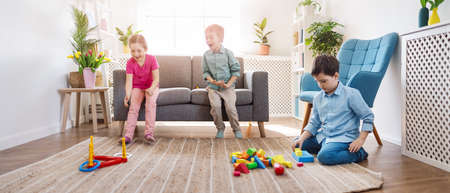 Playful children sitting in the living room on the Birthday party.の写真素材