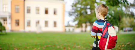 Cute child with backpack going to the schoolの写真素材