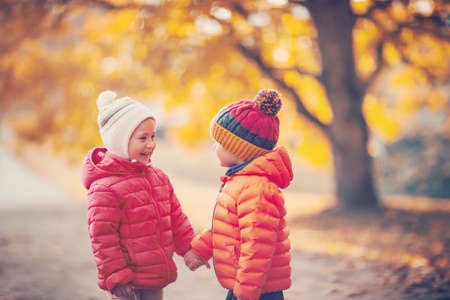 Two children playing in the park togetherの写真素材