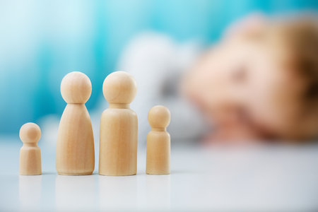 Wooden figures of the family on the blue backgroundの写真素材
