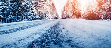 Closeup view of the beautiful country road in winter forest.の写真素材