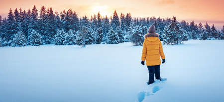 Active woman in the wilderness natural park on winter sunsetの写真素材