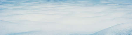 Panoramic view of the clear waved snowy field in winter.の写真素材