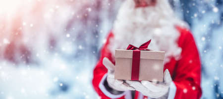 Santa Claus holding in his hands present box.の写真素材