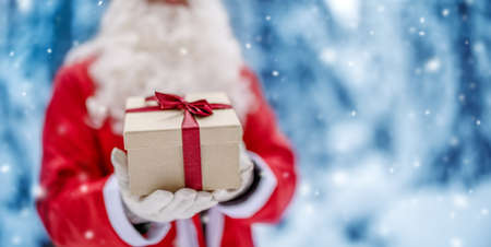 Santa Claus holding in his hands present box.の写真素材