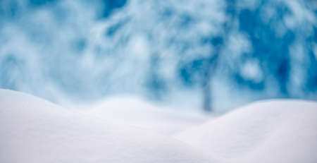 Snowy background with closeup view of the wavy snowdriftsの写真素材