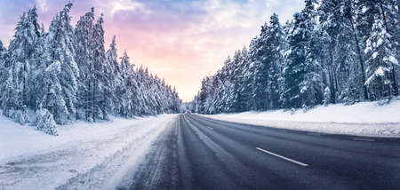 Beautiful view of the snowy curve country road in winterの写真素材