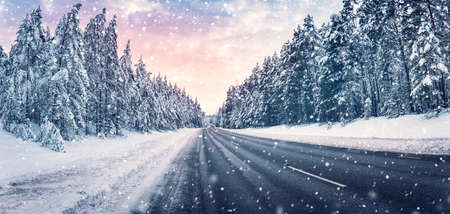 Beautiful view of the winter curve country road in snowstormの写真素材
