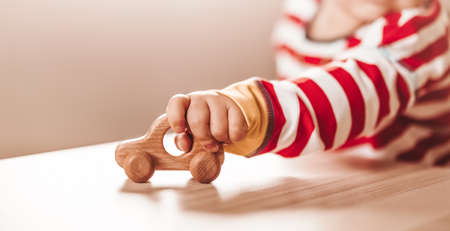 Little boy playing with wood car indoorの写真素材