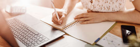 Woman writing in notebook at the office