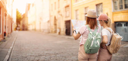 Two woman looking for the location of sights on the map of old Tallinn, Estonia.の写真素材