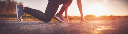 Woman starting to run outdoors in the eveningの写真素材
