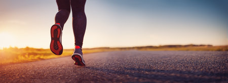 Woman running outdoors on the evening sunset.
