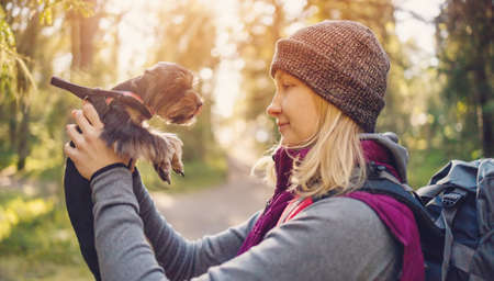 Young woman with dog in nature in the forestの写真素材
