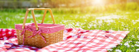 Picnic duvet with empty bascket on the meadow in nature.の写真素材