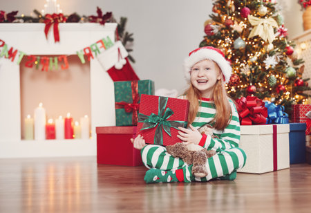 Little girl sitting in the Christmas decorating roomの写真素材