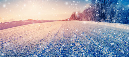Closeup view of the snowy dirty road in snowstorm in natural parkの写真素材