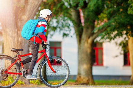 Teenager in the morning quickly riding on bicycle to the lesson.の写真素材