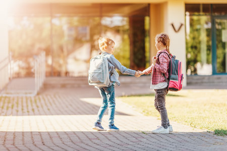 Girl and boy standing near the school together.の写真素材