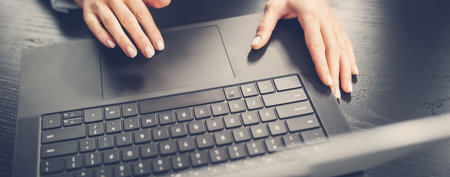 Woman with her laptop in the office and working.