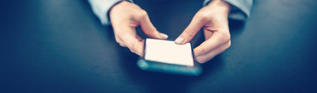 Woman holding in her hands a modern mobile phone.の写真素材