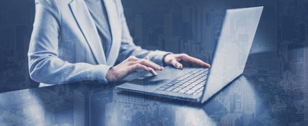 Woman with her laptop in the office and working.の写真素材
