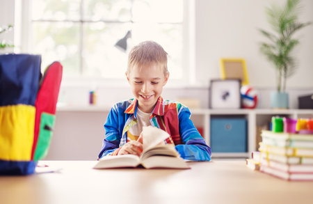 Happy boy smiling and turning pages.の写真素材