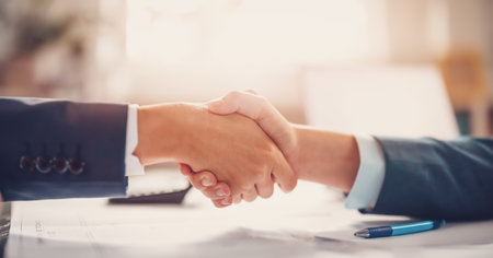 Businessmen shaking hands each other in the office.の写真素材