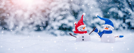 Little snowmen on the white snow on blue background.の写真素材