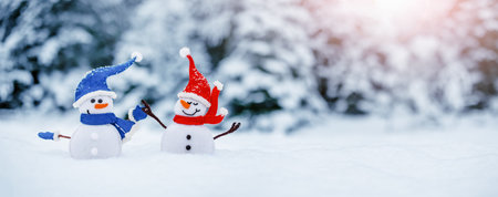 Little snowmen on the white snow on blue background.の写真素材
