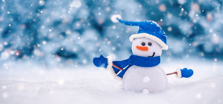 Little handmade snowman on the white snow on blue background.の写真素材