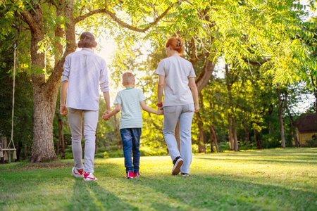 Family walking in the natural park with holding hands.の写真素材