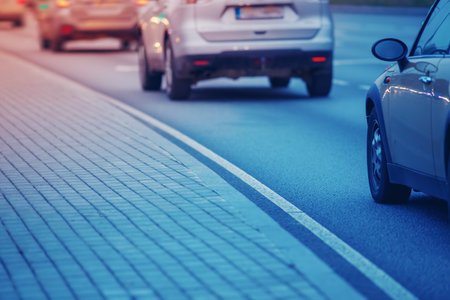 Cars standing in the row on the urban asphalt road.の写真素材