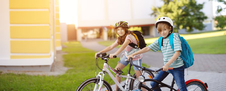 Boy and girl on the bicycles riding together.の写真素材