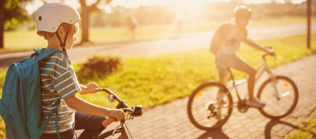 Boy and girl on the bicycles riding together.の写真素材