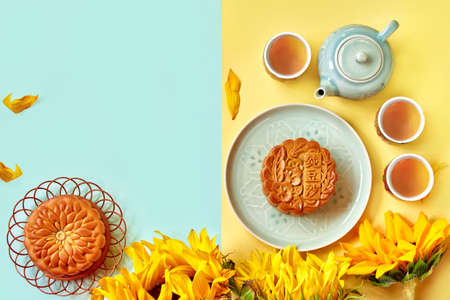 Chinese Mid Autumn Festival Moon cake and tea on color background. Moon cake Chinese text translation: Pure bean pasteの写真素材