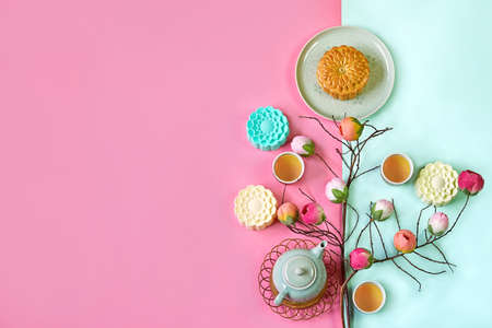 Traditional Mooncake with teapot on colorful background. Moon cake festival with copyの写真素材