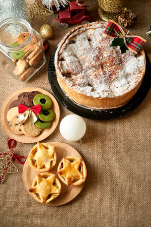 Christmas cake and cookies on rustic backgroundの写真素材