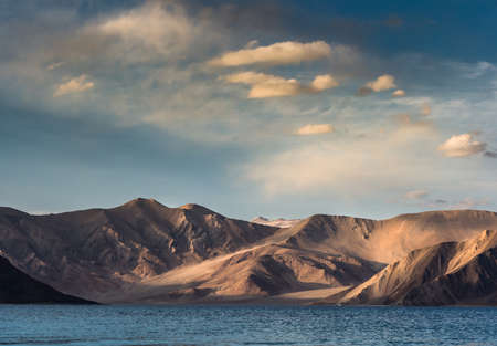 india, It is 134 km long and extends from India to Tibet. Leh, Jammu and Kashmir, ladakh, Pangong tso (Lake) with blue sky in background. It is huge lake in Ladakh, scenicの写真素材