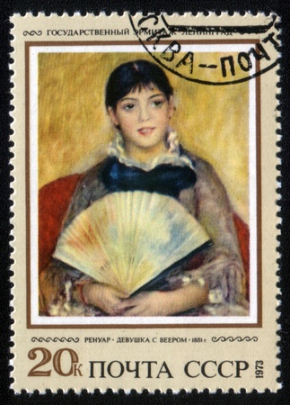 USSR - CIRCA 1973: A stamp printed in the USSR shows painting "Girl with a fan" by artist Pierre-Auguste Renoir, stamp from collection Hermitage, circa 1973.のeditorial素材