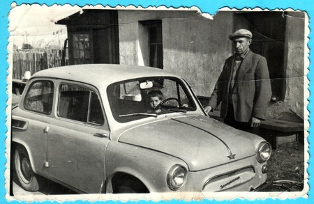 USSR - CIRCA 1962: little girl driving a car , circa 1962.のeditorial素材