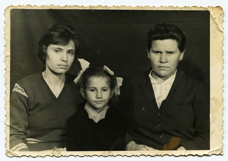 USSR - CIRCA 1970: An antique photo shows studio family portrait. Two woman and girlのeditorial素材