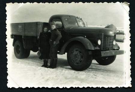 USSR - CIRCA 1950s : An antique photo shows man and woman near a military truck ZIL. "Soviet people" seriesのeditorial素材