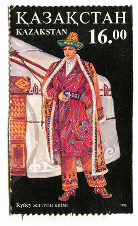 REPUBLIC OF KAZAKHSTAN - CIRCA 1996: A postage stamp printed in the Kazakhstan shows Kazakh man in national dress near nomad jurt, circa 1996のeditorial素材