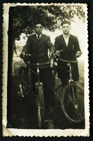 USSR - CIRCA 1975: Antique photo shows two men with bicycles, 1975