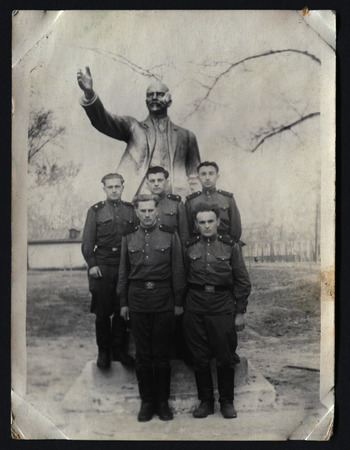 USSR - CIRCA 1953: An antique photo shows five men on the background of the Lenin statue, 1953のeditorial素材