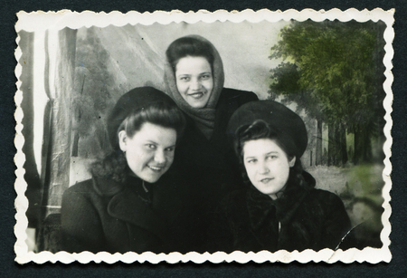 USSR - CIRCA 1970s: An antique photo shows  studio portrait of three women in winter clothes, USSR, circa 1970sのeditorial素材